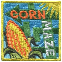 Arrows twist this way and that, confusing in their pattern on this square patch. In the bottom right a cob of corn sticks out and next to it are the words 'Corn Maze.'
