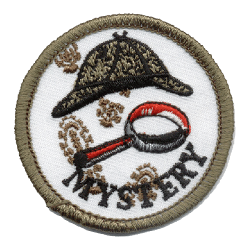 A round patch depicts Sherlock Holmes' hat along with a magnifying glass and muddy footprints. The word ''Mystery'' is embroidered at the bottom of the patch.