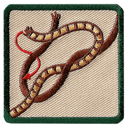 This square badge displays step two on how to make a square knot. Now cross the right side over the left and wrap around the other.