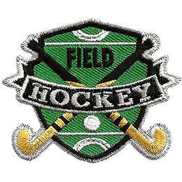 Two hockey sticks are crossed over each other with a ball on the shield-shaped field behind them. The words Field Hockey are stitched across the middle.