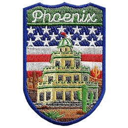The word Phoenix is above a tiered building in a desert. The flag of the USA is in the background.