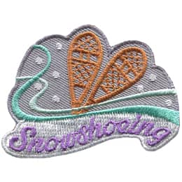 A pair of wooden snowshoes are on a background of snow and wind. The word Snowshoeing is embroidered across the bottom.