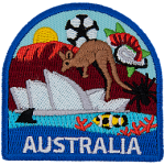 This patch displays a wide variety of Australian culture including: a kangaroo, they Sydney Opera House, a spider, a shark fin, a clown fish, the Great Barrier Reef, Ayers Rock, and a soccer ball/foot ball.