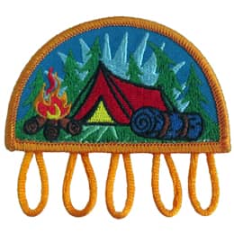 A tent sits in the middle of a treed forest. A roaring campfire rests before the tent at the bottom left of the patch and a bedroll sits at the bottom right. Five loops dangle from the base of this patch for which you can attach charms too.