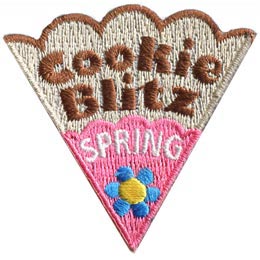 The words Cookie Spring Blitz are on a cookie slice with pink icing and a blue flower.