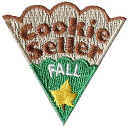 The words Cookie Seller Fall are on a cookie slice with green icing and a yellow leaf.