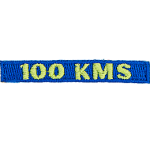 The number 100 KMS is stitched in yellow on a dark blue background.