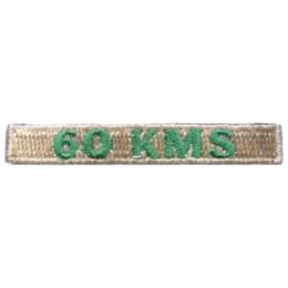 The words 60 KMS is stitched in green on a cream-coloured background.