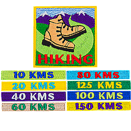 A large patch with hiking boots and eight smaller patches with different numbers of kilometres stitched on them.