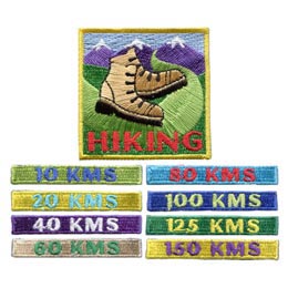 A large patch with hiking boots and eight smaller patches with different numbers of kilometres stitched on them.