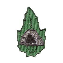 A rocky cave is in the center of a green leaf.