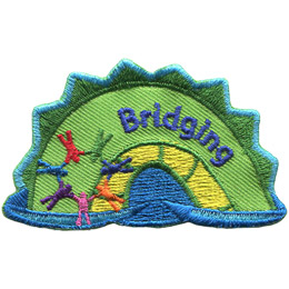 The middle hump of a sea serpent. The word 'Bridging' is embroidered along the middle of the hump. A rainbow ring of people connected at the hands rests on the left most section of the hump.